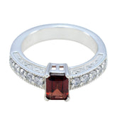 Victoria red gemstone halo ring with rectangular red stone and clear stones on silver band