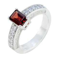 Victoria red gemstone halo ring with rectangular red center stone and diamond-studded silver band
