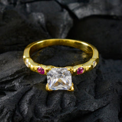 Saanvi gold ring featuring a clear center stone with small red gemstones red gemstone ring for women