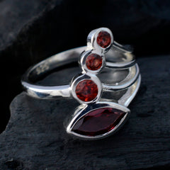 Ayesha silver red gemstone ring for women with multiple red stones on a dark background
