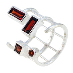 Elena silver ring featuring four red gemstones in a unique open signet ring design