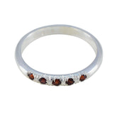 Yuki red gemstone silver ring with multiple small red stones set on a polished silver band
