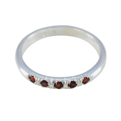 Yuki red gemstone silver ring with multiple small red stones set on a polished silver band