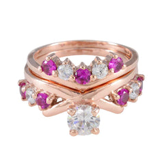 Naomi rose gold V chevron stacking ring set with pink and clear stones and solitaire center red gemstone stacking ring