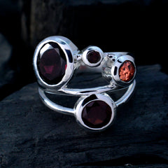 Nisa red gemstone statement ring with multiple red stones set in polished silver band