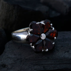 Luna red gemstone statement ring with dark red heart-shaped stones arranged in a flower design