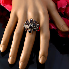 Chloe red gemstone statement ring with multiple red stones in floral design on hand