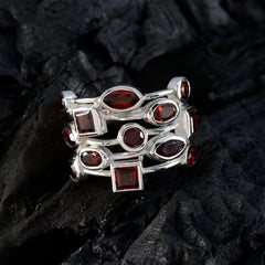 Freya red gemstone statement ring with multiple red stones set in silver band on black background
