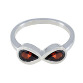 Silver ring featuring a red gemstone toi et moi ring design with two marquise-cut stones