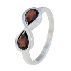 Tereza red gemstone toi et moi ring featuring two pear-shaped red gemstones set in silver band