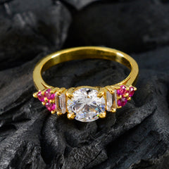 Araya gold ring featuring a red halo gemstone ring design with central clear stone and surrounding red gemstones
