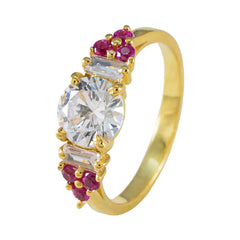 Araya red halo gemstone ring with gold band and round clear center stone surrounded by red gemstones