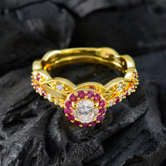 Laura gold ring featuring a red halo promise ring design with central clear stone and red gemstones