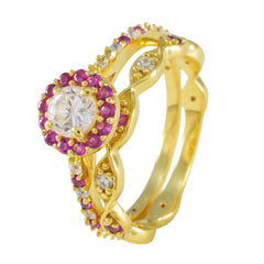 Gold ring with a central diamond surrounded by red stones in a red halo promise ring design