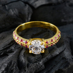 Xiu red halo ring gold with a large central diamond and small red stones on gold band