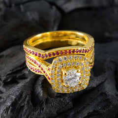 Isla gold red halo ring with central round diamond and small red and clear stones