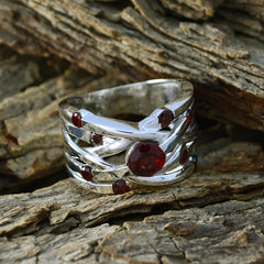 Mariana red navratna ring for women with multiple red stones set in silver band on rustic wood