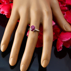 Nova red solitaire ring for women with oval red gemstone on silver band displayed on mannequin hand