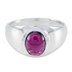 Audrey red solitaire ring with a polished silver band and oval red gemstone centerpiece
