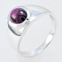 Audrey red solitaire ring with a polished silver band and round red gemstone