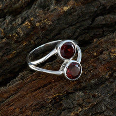 Olivia red toi et moi ring with two red gemstones set in silver band on textured bark