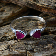 Nisa red toi et moi ring with two triangular deep red stones set in sterling silver open band on rustic wood