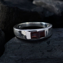 Camilla silver band red toi et moi ring with two square red gemstones on dark textured background
