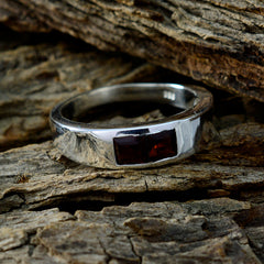 Camilla silver ring featuring two rectangular red stones red toi et moi ring on textured wood