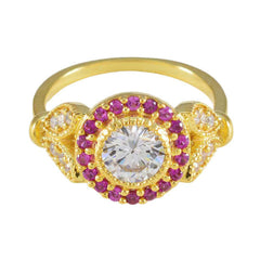 Jia romantic red halo ring with gold band and center clear gemstone surrounded by red stones