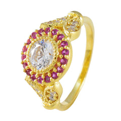 Jia romantic red halo ring featuring a central clear stone surrounded by red gemstones on a gold band