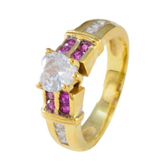 Daniela romantic red halo ring with gold band, central clear gem, and red accent stones
