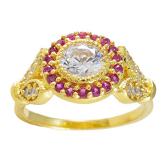 Jia gold ring with central clear stone surrounded by small red gems romantic red halo ring
