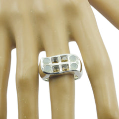 savannah cocktail ring silver wide band with four square smoky stones and four round moonstone accents on hand