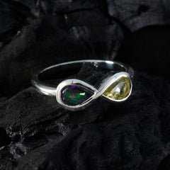 Li Lee Toi et Moi gemstone ring with two pear-shaped green and yellow gemstones set in silver band