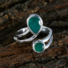 Hanna toi et moi ring green gemstone with two green stones set in silver band on rustic wood