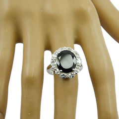 Leah trendy black statement ring with large black stone and clear surrounding gems on display hand