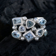 Nisa trendy blue gemstone ring with various shapes set in silver band on black fabric