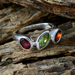 Angel trendy gemstone trilogy ring with red, green, and orange stones set in silver band