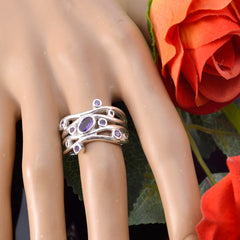 Angel trendy green gemstone ring with multiple purple stones on silver band worn on mannequin hand