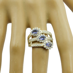 Trendy multicolor trilogy ring by María with three purple stones and diamond accents on a gold band