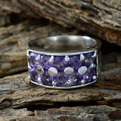 Ivana trendy purple gemstone ring with multiple purple stones set in a silver band on rustic wood