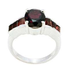 Andrea trendy red gemstone ring with a round center stone and rectangular side stones in silver band