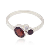 Yan trendy red gemstone ring with three stones set on a sleek silver band