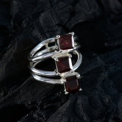 Natcha trendy red trilogy ring with three square red gemstones set on a polished silver triple band