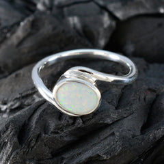Ananya trendy white solitaire ring with oval opal stone set in silver band on dark textured surface