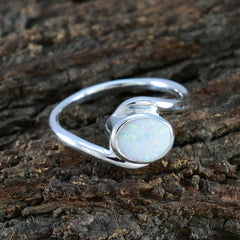 Ananya trendy white solitaire ring with oval white stone set in silver band on textured bark