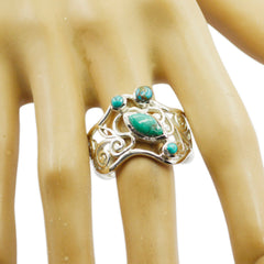 Putri turquoise filigree ring with intricate silver detailing worn on finger