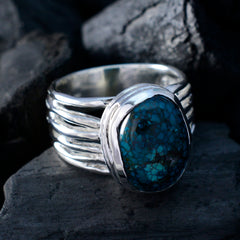 Emilia turquoise solitaire ring with a polished silver band and oval blue-green stone