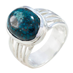 Emilia turquoise solitaire ring with silver band and oval blue stone centerpiece