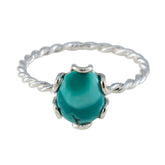 Freya turquoise solitaire ring with twisted silver band and oval turquoise gemstone centerpiece